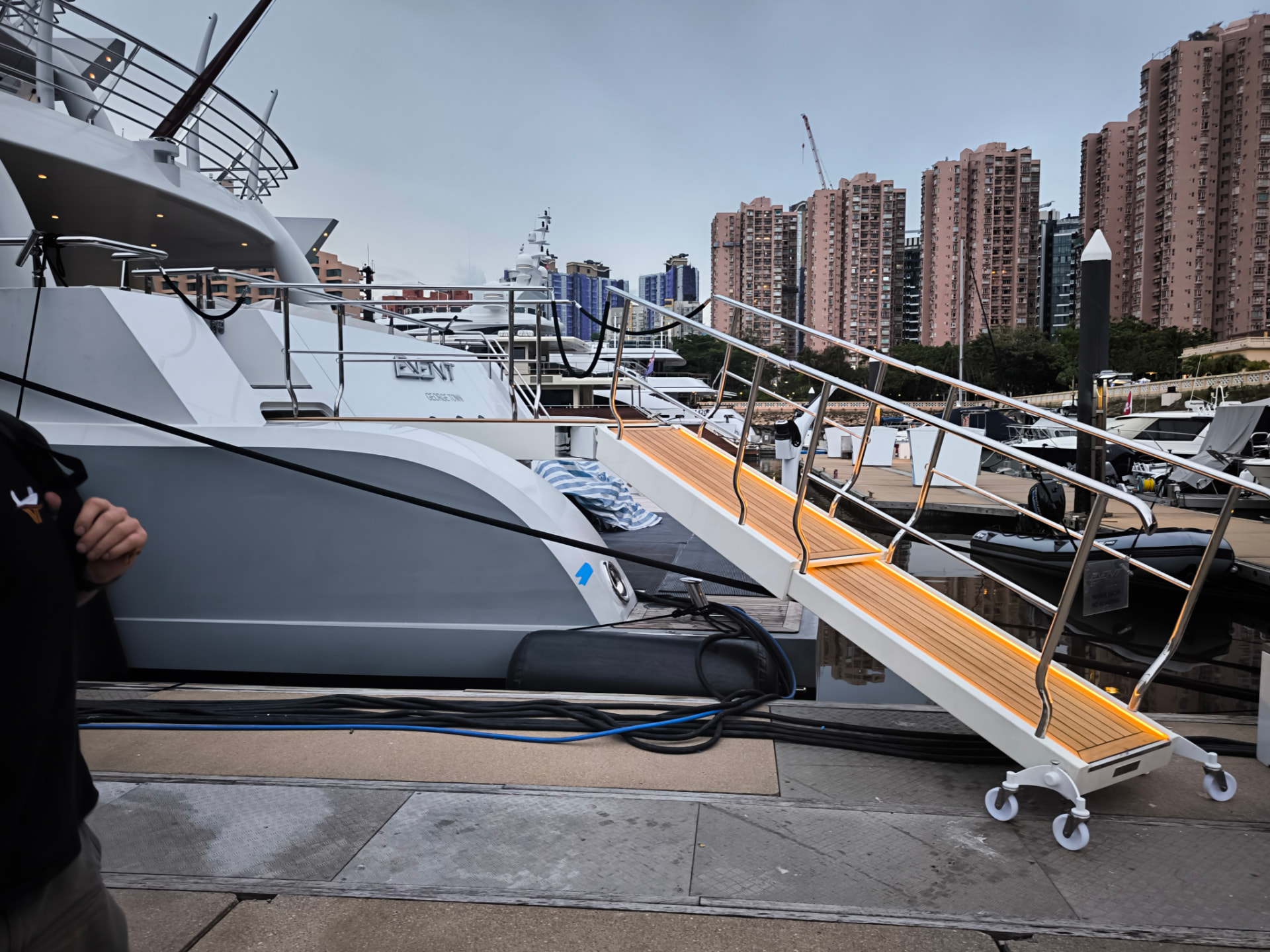 Completed passarelle deployed to the dock with teak treads and rope guardrails