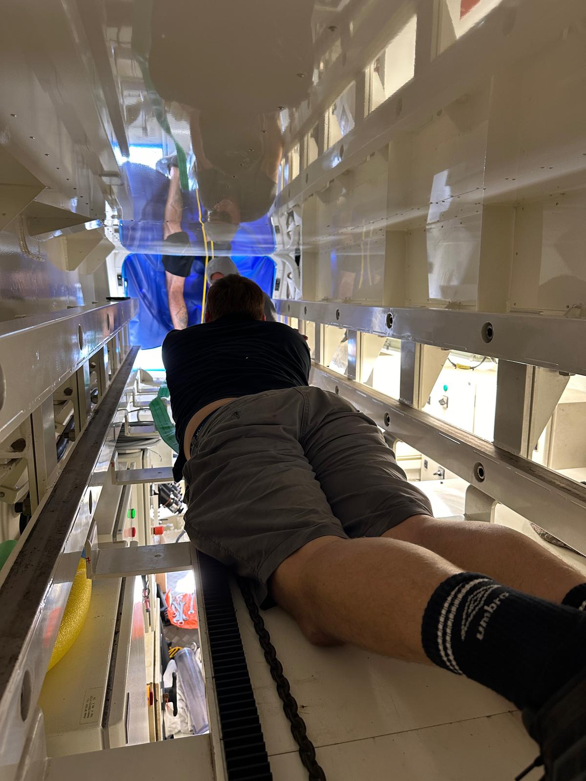 Engineer working inside the passarelle housing during fit-up
